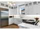 Gorgeous white kitchen featuring marble countertops, stainless steel appliances and custom cabinetry at 348 W Portland St, Phoenix, AZ 85003