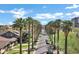 Lush neighborhood street with tall palm trees lining the road with clear blue skies at 348 W Portland St, Phoenix, AZ 85003