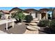 Inviting single-level home with desert landscaping, stepping stone entryway, and golf course nearby at 3685 N 162Nd Ln, Goodyear, AZ 85395