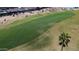 Aerial shot of a meticulously kept golf course featuring lush green fairways near well-maintained homes at 3685 N 162Nd Ln, Goodyear, AZ 85395