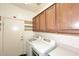 Convenient laundry room with a washer, dryer, and ample storage space at 3685 N 162Nd Ln, Goodyear, AZ 85395