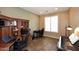 Home office with ample desk space, built-in shelving, and natural light from a bright window at 3685 N 162Nd Ln, Goodyear, AZ 85395