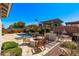 Entertain in this beautiful backyard with an outdoor kitchen, fire pit, seating area and waterfall feature at 3851 E Vallejo Dr, Gilbert, AZ 85298