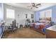 This carpeted bedroom features blue and white paint, ceiling fan, and window with shutters at 3851 E Vallejo Dr, Gilbert, AZ 85298