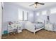 Sunny bedroom with a desk, white furniture, and plantation shutters has a cozy ambiance at 3851 E Vallejo Dr, Gilbert, AZ 85298