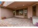 Inviting covered back patio with brick pavers, perfect for entertaining, with multiple access doors at 3881 S Marion Way, Chandler, AZ 85286