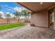 Covered back patio with decorative pavers, providing an ideal outdoor living space and backyard access at 3881 S Marion Way, Chandler, AZ 85286