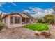 Backyard with manicured lawn, mature landscaping, brick-paved patio, and cozy outdoor seating at 3881 S Marion Way, Chandler, AZ 85286