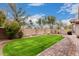 Expansive backyard featuring a manicured lawn, mature trees, and a brick-paved patio at 3881 S Marion Way, Chandler, AZ 85286