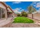 Lush backyard featuring well-maintained lawn, mature trees, and an extended brick-paved patio at 3881 S Marion Way, Chandler, AZ 85286