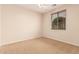 Sunny bedroom with neutral walls, carpet, and a window overlooking the yard for natural light at 3881 S Marion Way, Chandler, AZ 85286