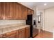 This kitchen features rich wood cabinets, tile countertops, and stainless steel refrigerator at 3881 S Marion Way, Chandler, AZ 85286