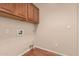 Functional laundry room with overhead cabinetry, utility connections, and durable flooring at 3881 S Marion Way, Chandler, AZ 85286