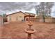 Expansive backyard featuring a water feature, pergola, and block fence providing privacy at 40401 W Hayden Dr, Maricopa, AZ 85138