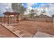 Large backyard features a wooden pergola and an outdoor water fountain at 40401 W Hayden Dr, Maricopa, AZ 85138