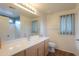 Bright bathroom features a vanity with wood cabinets and a shower with blue tile accents at 40401 W Hayden Dr, Maricopa, AZ 85138