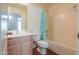 Well-lit bathroom with a combined shower and bathtub, a vanity, and a wood-look floor at 40401 W Hayden Dr, Maricopa, AZ 85138