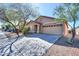 Inviting single-story home with desert landscaping, a concrete driveway, and a convenient two-car garage at 40401 W Hayden Dr, Maricopa, AZ 85138