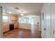 Kitchen featuring wood cabinets, black appliances, and an arched doorway to the living room at 40401 W Hayden Dr, Maricopa, AZ 85138