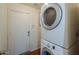 Laundry room featuring a stacked washer and dryer with a utility door leading to the exterior at 40401 W Hayden Dr, Maricopa, AZ 85138