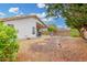 Serene backyard featuring a covered patio, desert landscaping, and mature trees at 4145 W Columbine Dr, Phoenix, AZ 85029