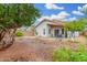 Enclosed backyard featuring a covered patio with outdoor seating and desert landscaping at 4145 W Columbine Dr, Phoenix, AZ 85029