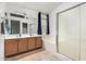 Well-lit bathroom featuring double sinks, bathtub, and enclosed shower at 4145 W Columbine Dr, Phoenix, AZ 85029