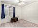 Cozy bedroom with neutral carpet, window, and ceiling fan at 4145 W Columbine Dr, Phoenix, AZ 85029