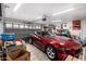 Organized garage featuring a red sports car and storage solutions at 4145 W Columbine Dr, Phoenix, AZ 85029