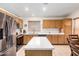 Well-lit kitchen featuring ample counter space, stainless steel appliances, and wood cabinets at 4145 W Columbine Dr, Phoenix, AZ 85029