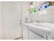 Functional laundry room with washer, dryer, and storage shelves at 4145 W Columbine Dr, Phoenix, AZ 85029