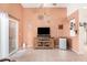 Bright living room featuring a wooden media cabinet, tile flooring, and access to the patio at 4145 W Columbine Dr, Phoenix, AZ 85029