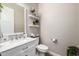 Clean, half bathroom with marble vanity, decor, and wood-look tile flooring at 4319 W Winslow Way, Eloy, AZ 85131