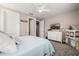 Well-lit bedroom boasting a queen-sized bed, dresser with a TV, and ample natural light at 4319 W Winslow Way, Eloy, AZ 85131