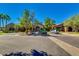 Community clubhouse entrance featuring stone accents, lush landscaping, and convenient parking for residents and guests at 4319 W Winslow Way, Eloy, AZ 85131