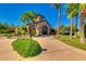 Elegant clubhouse facade surrounded by palm trees and manicured grounds creating a sophisticated community atmosphere at 4319 W Winslow Way, Eloy, AZ 85131