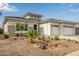 Beautiful home exterior with a three-car garage and desert landscaping at 4319 W Winslow Way, Eloy, AZ 85131