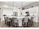 This kitchen features a large island with seating, pendant lighting, and stainless steel appliances at 4319 W Winslow Way, Eloy, AZ 85131