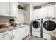 Well-organized laundry room with white cabinetry, granite countertops, and modern appliances at 4319 W Winslow Way, Eloy, AZ 85131