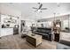 The spacious living room connects to a modern kitchen and has wood-look tile floors at 4319 W Winslow Way, Eloy, AZ 85131