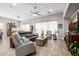 Bright and inviting living room features a ceiling fan, stylish furniture, and wood-look tile floors at 4319 W Winslow Way, Eloy, AZ 85131