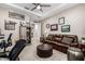 Relaxing living room with a leather sofa, sports memorabilia, and a stylish ottoman at 4319 W Winslow Way, Eloy, AZ 85131