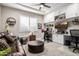 Inviting living room with a comfortable leather sofa, built-in shelves, and a modern workspace at 4319 W Winslow Way, Eloy, AZ 85131