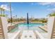 View of a backyard swimming pool with lounge chairs, umbrellas and well maintained desert landscaping at 4319 W Winslow Way, Eloy, AZ 85131