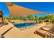 Outdoor pool with sunshade, surrounded by lounge chairs and desert landscaping at 4319 W Winslow Way, Eloy, AZ 85131