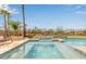 Inviting pool and spa with stone accents and lush landscaping create a relaxing outdoor oasis at 4319 W Winslow Way, Eloy, AZ 85131