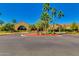 The Ranch House sign and entrance adorned with lush landscaping and palm trees creating a welcoming community landmark at 4319 W Winslow Way, Eloy, AZ 85131