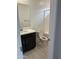 Bathroom featuring a single sink vanity with black cabinets and a white countertop at 43387 N Wollemi St, Queen Creek, AZ 85140