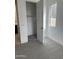 Bedroom with gray carpet and a walk-in closet adjacent to an en-suite bathroom at 43387 N Wollemi St, Queen Creek, AZ 85140