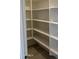 Walk-in pantry featuring multiple shelves and tile floors, perfect for kitchen storage at 43387 N Wollemi St, Queen Creek, AZ 85140